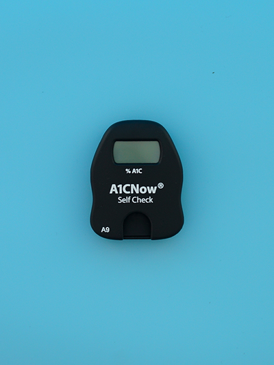 A1C home test kit meter only on blue background